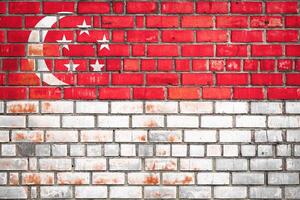 National  flag of the Singapore  on a grunge brick background. photo