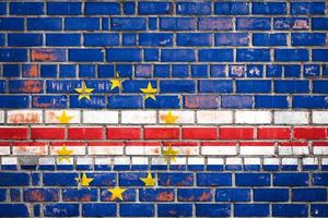 National  flag of the Cape Verde on a grunge brick background. photo