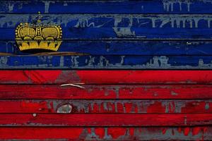 The national flag of Liechtenstein is painted on uneven boards. Country symbol. photo