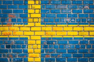 National  flag of the Sweden  on a grunge brick background. photo