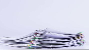 4K-Stop motion Stack overload document report paper with colorful paperclip on white background and copy space, business concept footage paperless used. video