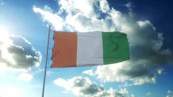 Flag of Ivory Coast waving at wind against beautiful blue sky. 3d illustration photo
