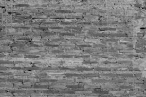 fondo de textura en blanco y negro, pared de mortero de ladrillo rojo, construcción en capas de la solapa de la casa. foto