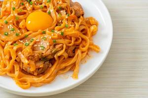 stir-fried udon noodles with kimchi and pork photo