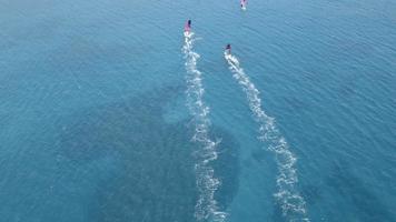 Wind surfers in action. Aerial view of speeding windsurfers. A windsurfers with their magnificent views are having a wonderful day in Alacati, cesme Turkey at sunset. video
