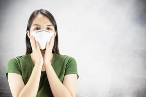 Young lady wearing mask protect fine dust in air pollution environment - people with protection equipment for air pollution concept photo