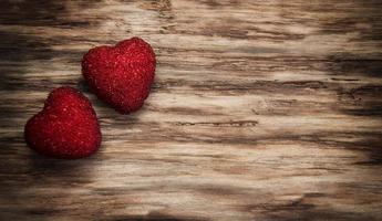 Red hearts on a wooden background photo