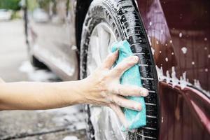 Man wash car using shampoo - every day life car care concept photo