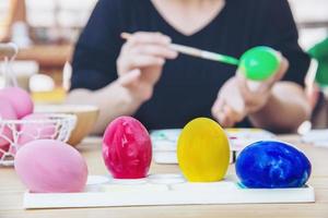 People painting colourful Easter eggs - people celebration national holiday concept photo