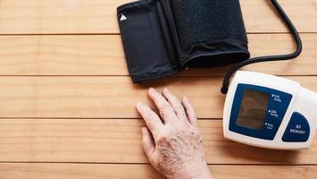 Old lady is being checked blood pressure using blood pressure monitor kid set - people with health care medical instrument set concept photo