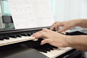 Man hand play electone keyboard - people with music concept photo