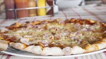 Family lunch eating pizza ham cheese recipe - people with favour italian dish concept photo