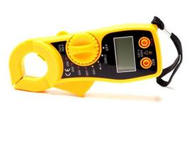 Picture of yellow digital clamp meter that using for measuring electrical current, voltage and resistance photo