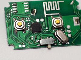 Green Printed Circuit Board PCB with some Surface Mount Device SMD components and chips photo