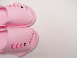 Picture of pink sendals that has shark shape photo