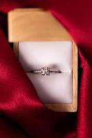 Diamond Wedding Ring Red Fabric photo