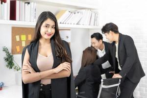 businesswoman smiling happy standing with arms crossed gesture at the office during business meeting. photo