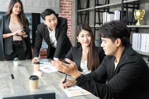 Happy group of businesspeople during presentation. Business people working as a team at the office photo