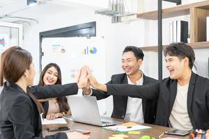 Teamwork friendship group brainstorming togetherness. Business people team holding hands Solidarity. teamwork and successful projects, standing in indoor office. photo