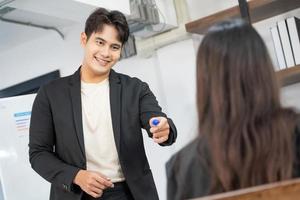 Selective Focus. Business presentation. project manager pointing at desktop presenting statistical data, briefing diverse group of employees. demonstrates statistics. photo