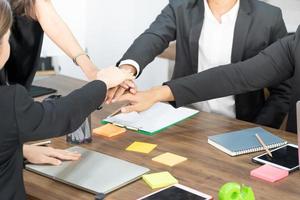 Teamwork friendship group brainstorming togetherness. Diversity business partner people teamwork holding hands together power of tag team. happy smiling colleagues with name tags stacking hands. photo