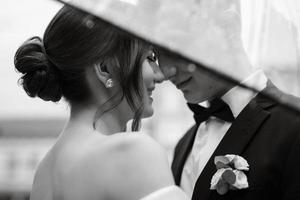 young couple bride and groom in a white short dress photo