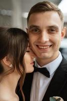 young couple bride and groom in a white short dress photo