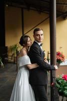 young couple bride and groom in a white short dress photo