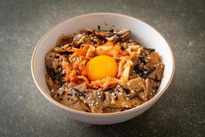 pork bulgogi rice bowl with kimchi and Korean pickled egg photo