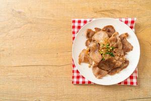 grilled pork neck sliced on plate photo