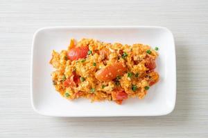 Stir-fried tomatoes with egg or Scrambled eggs with tomatoes photo