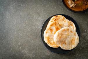 Chicken curry soup with roti photo