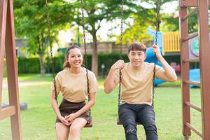 Asian couple love play on the swing photo