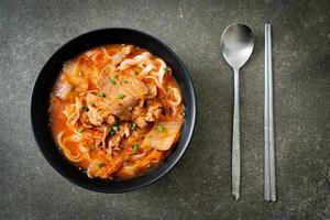 Korean udon ramen noodles with pork in kimchi soup photo