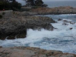 Rough sea, waves crashing against the rocks photo