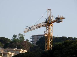 Crane at work on a building site transporting materials photo