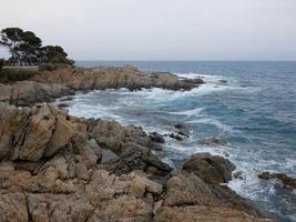 Rough sea, waves crashing against the rocks photo