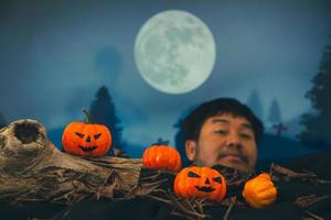 Spooky cemetery with glow halloween pumpkin photo