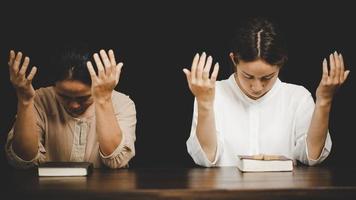 Two women praying worship believe photo