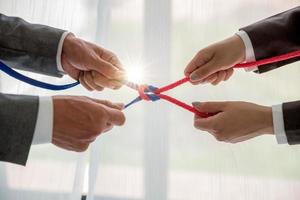 Teamwork businessman team, team people hold rope partnership, cooperation, concept. photo