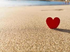 red hearts on the sea beach background photo