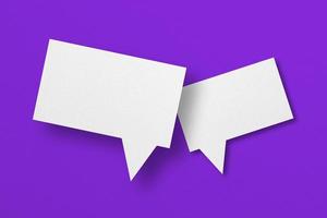 white paper with speech bubbles isolated on purple background photo