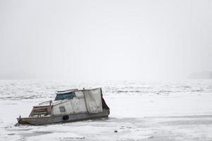Boat on a frozen river photo