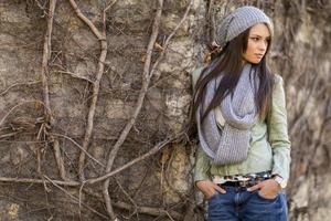 Young woman by the wall photo