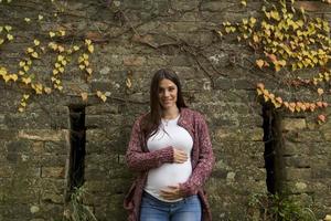 Young pregnant woman in the autumn park photo