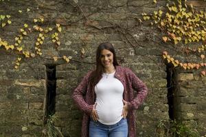 Young pregnant woman in the autumn park photo