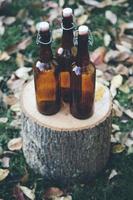 Glass bottles on wooden stack photo