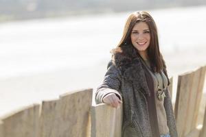 Young woman by the fence photo