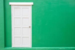White door classic vintage on the color green wall background photo