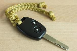 car key on wood table photo